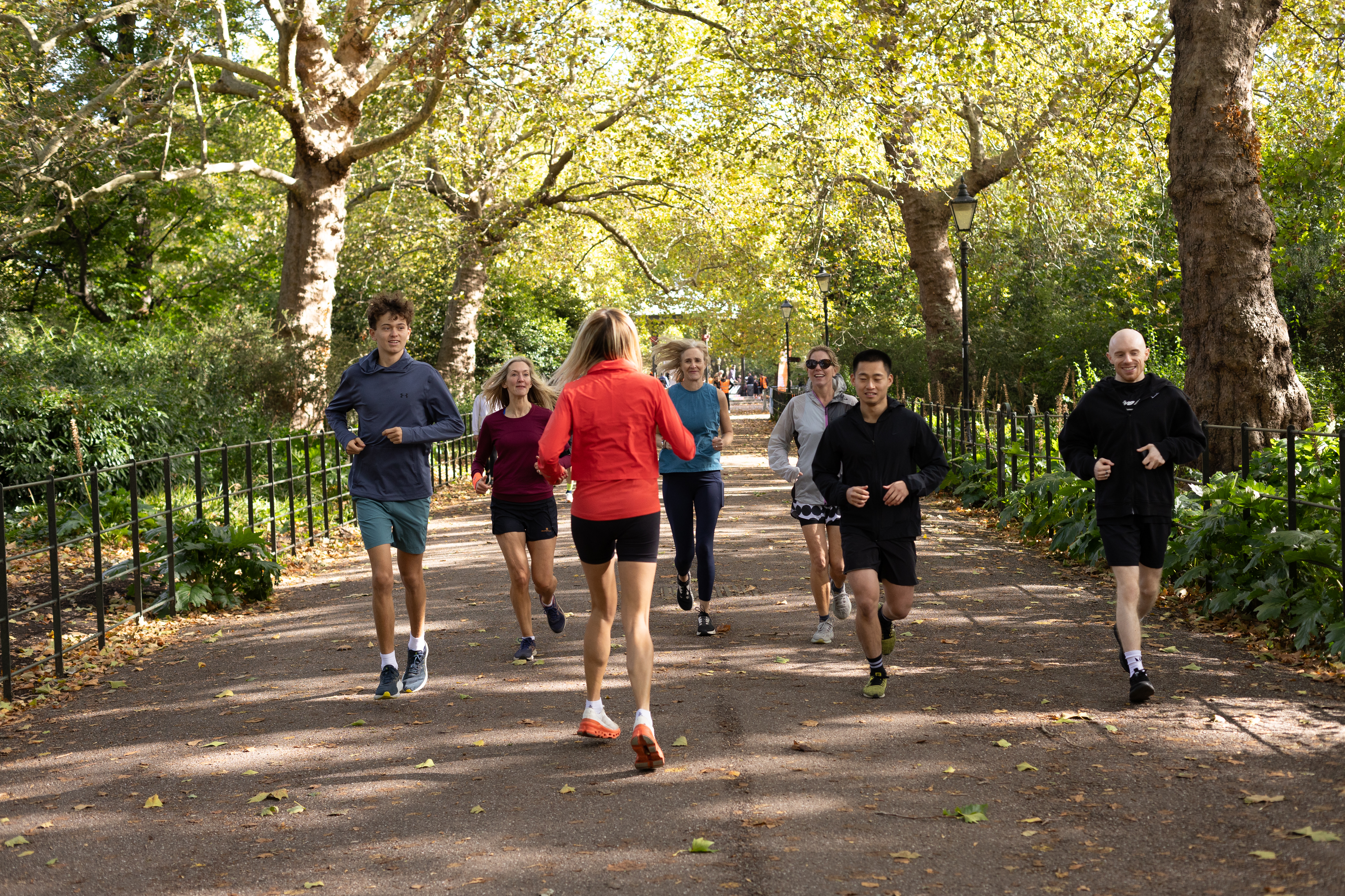 Runners on a guided tour through a London park